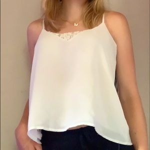 White tank top with floral center accent. No damages